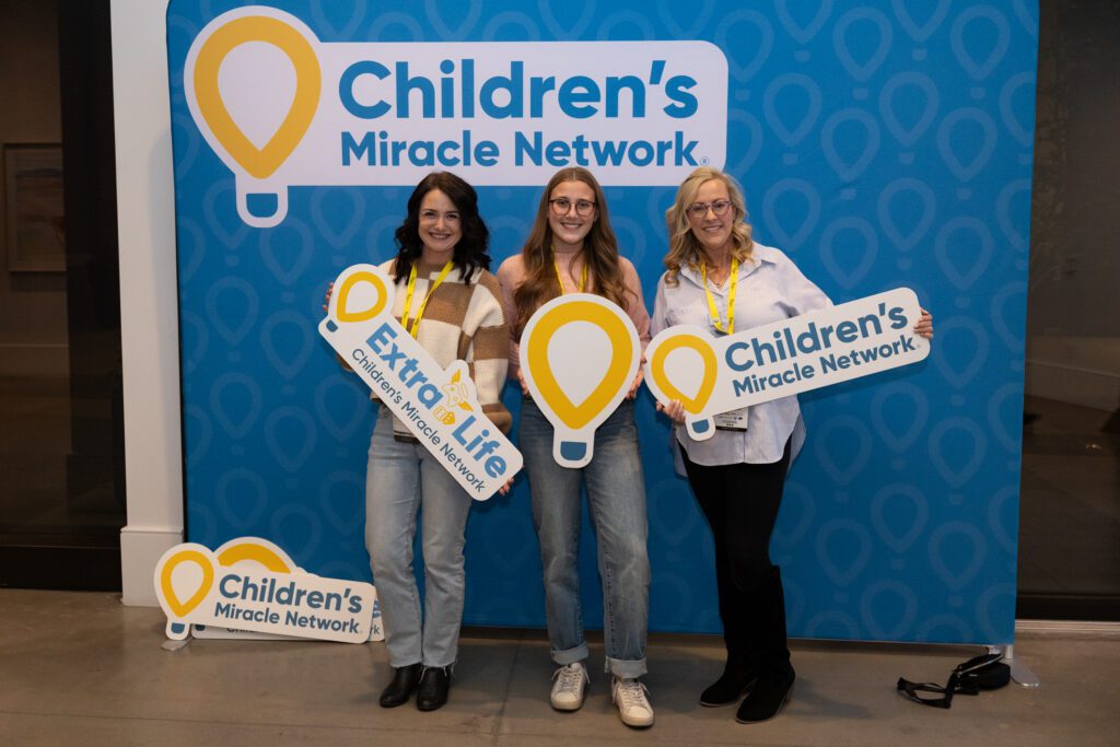 Three CMN supporters at the new brand photobooth.